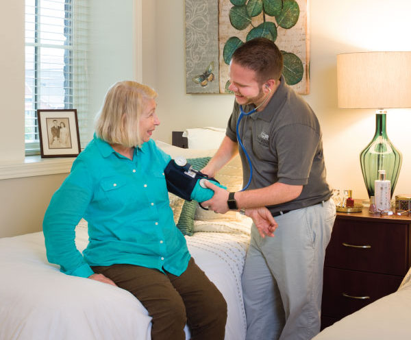 Image of elderly woman receiving a check up.